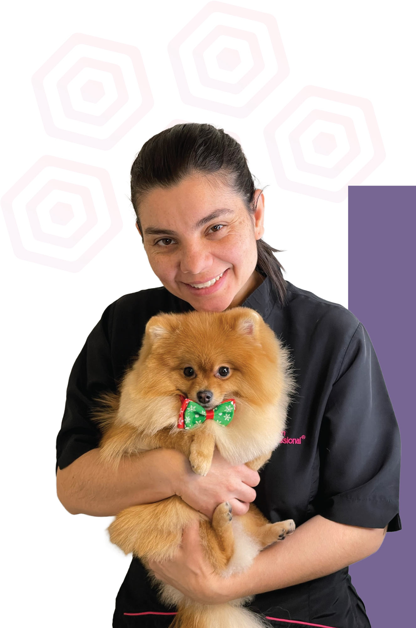 Diana Paiva smiles holding a Pomeranian wearing a bowtie