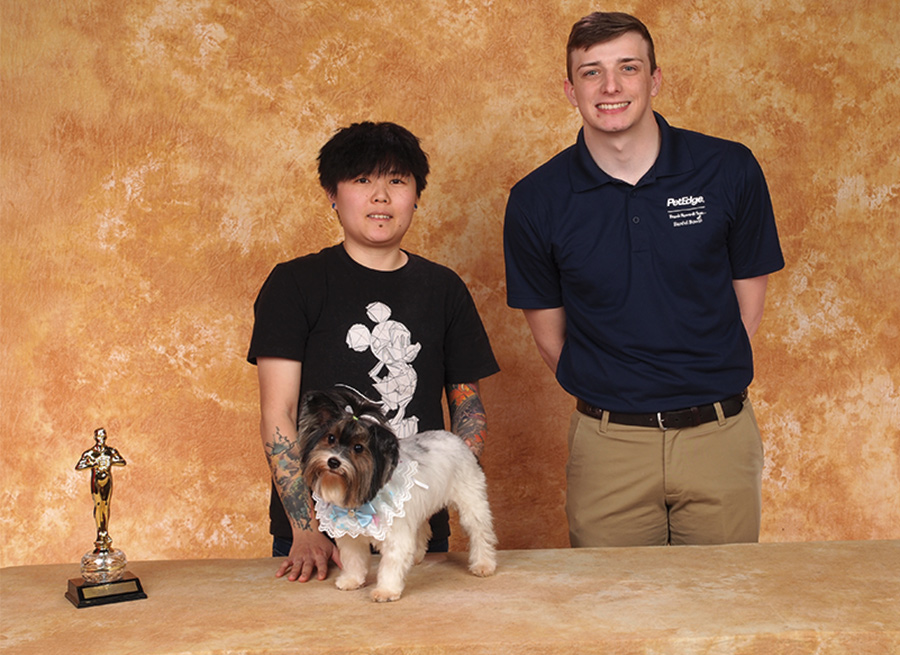 Wylie Shen with a small dog and the Petedge Sponsor