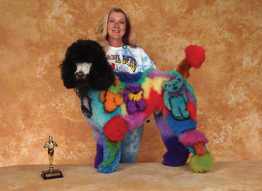 Suzanne Castleman with a dog with colored styled hair 