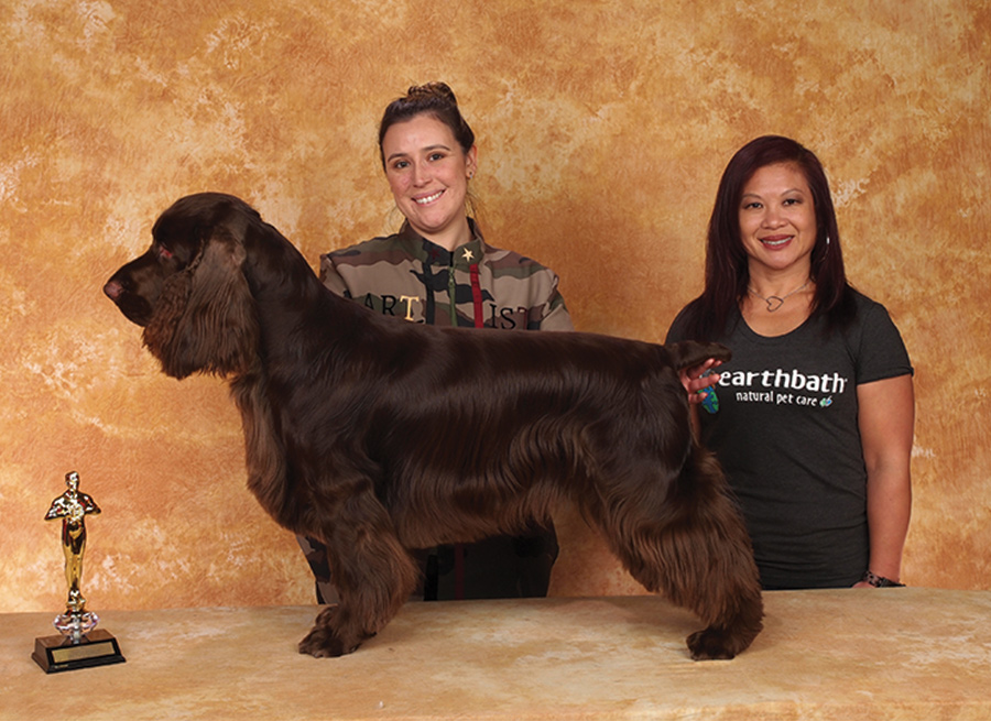 Mara Serpa with a brown fluffy dog and the Earthbath sponser