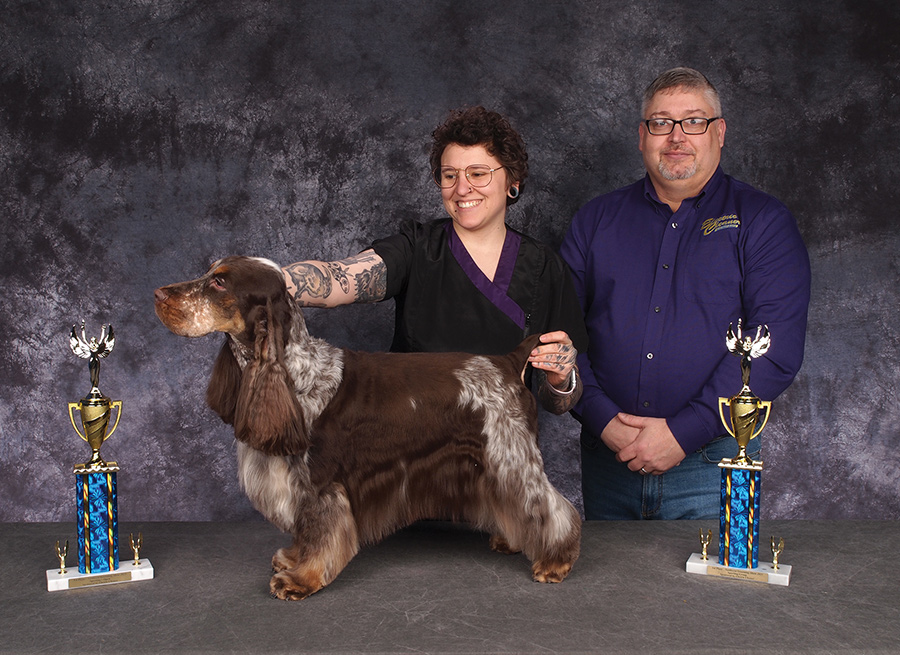 Nadia Bongelli posing with a dog and the sponsor from ELECTRIC CLEANER CO.