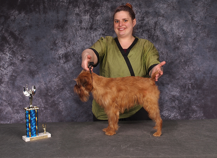 Amanda Thomas posing with a brown dog