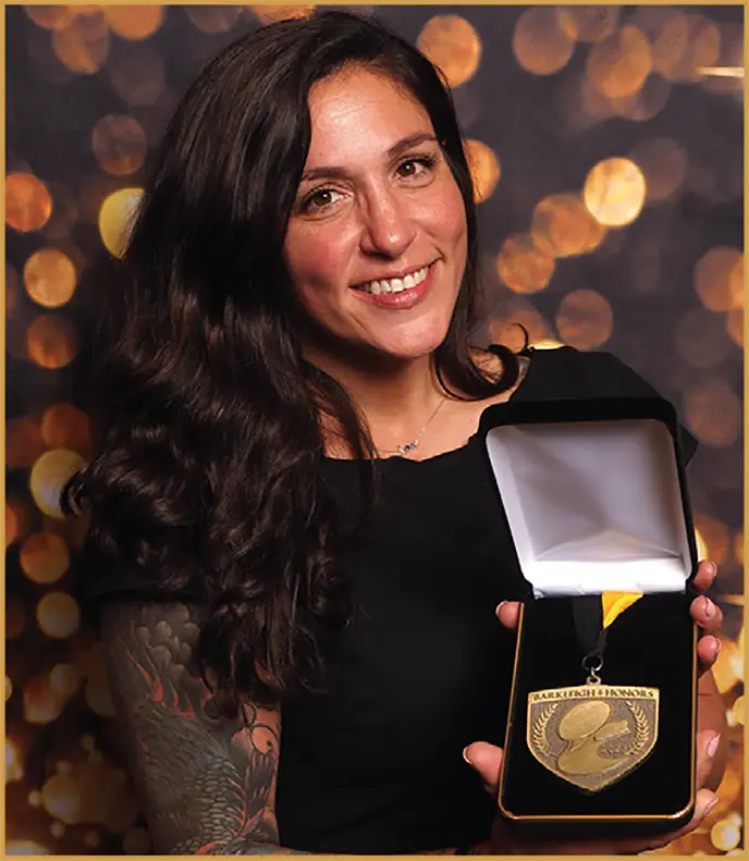 Mackensie Murphy holds up an award as she smiles