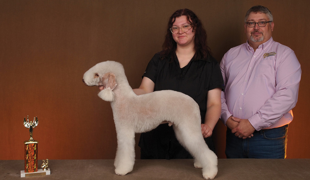 Marci Wanta posing with a dog and a trophy