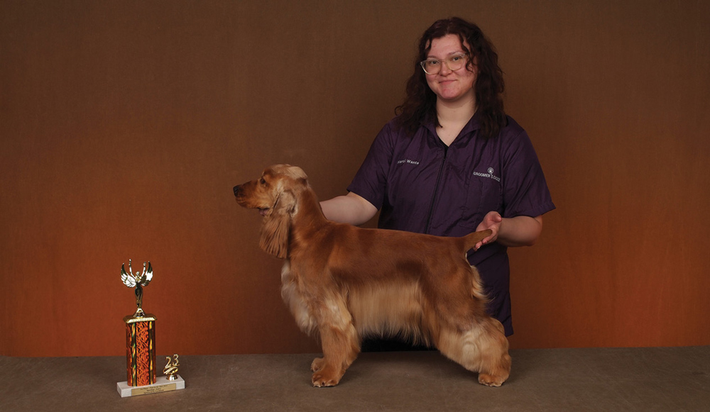 Marci Wanta posing with a dog and a trophy