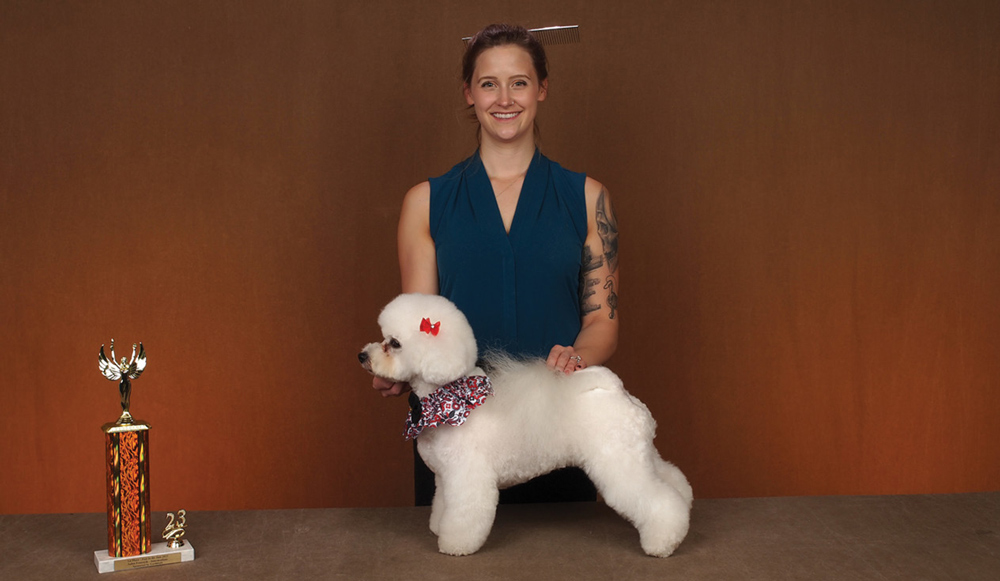 Anna Stowell posing with a dog and a trophy