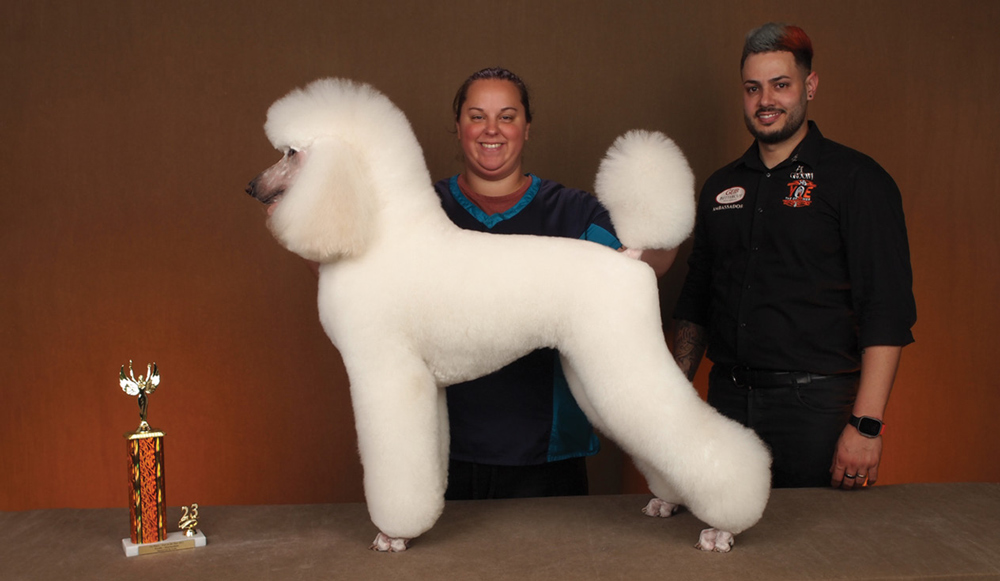 Courtney Crowley posing with a dog and a trophy