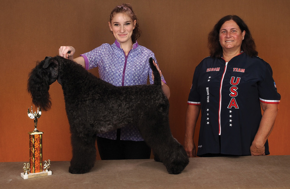 Cheyanne Davis posing with a dog and a trophy