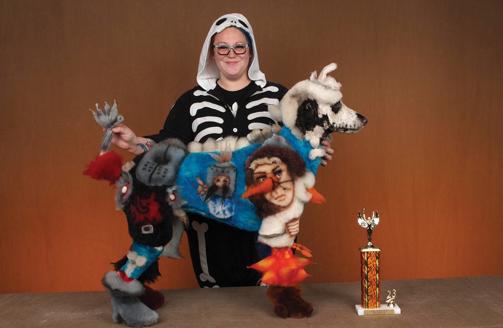 Alyssa Kasiba posing with a dog and a trophy