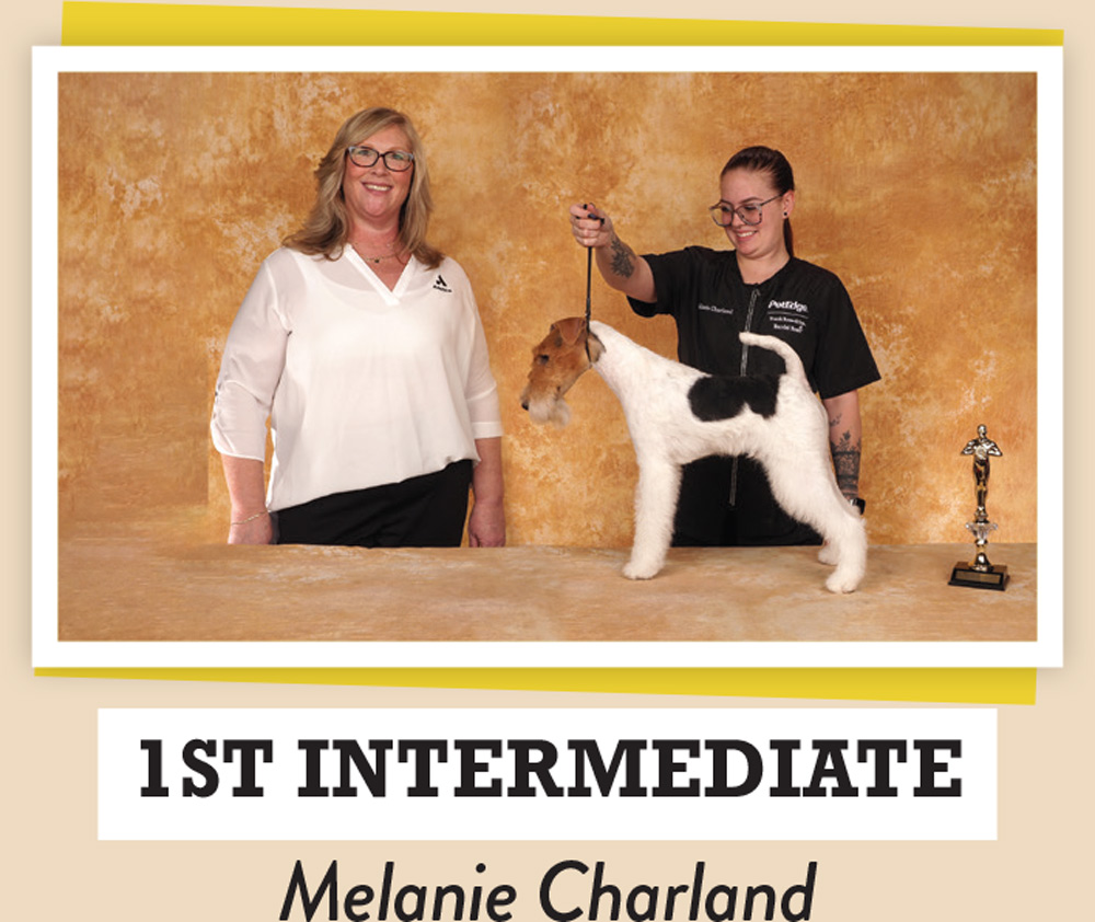 Melanie Charland posing with a dog and a trophy