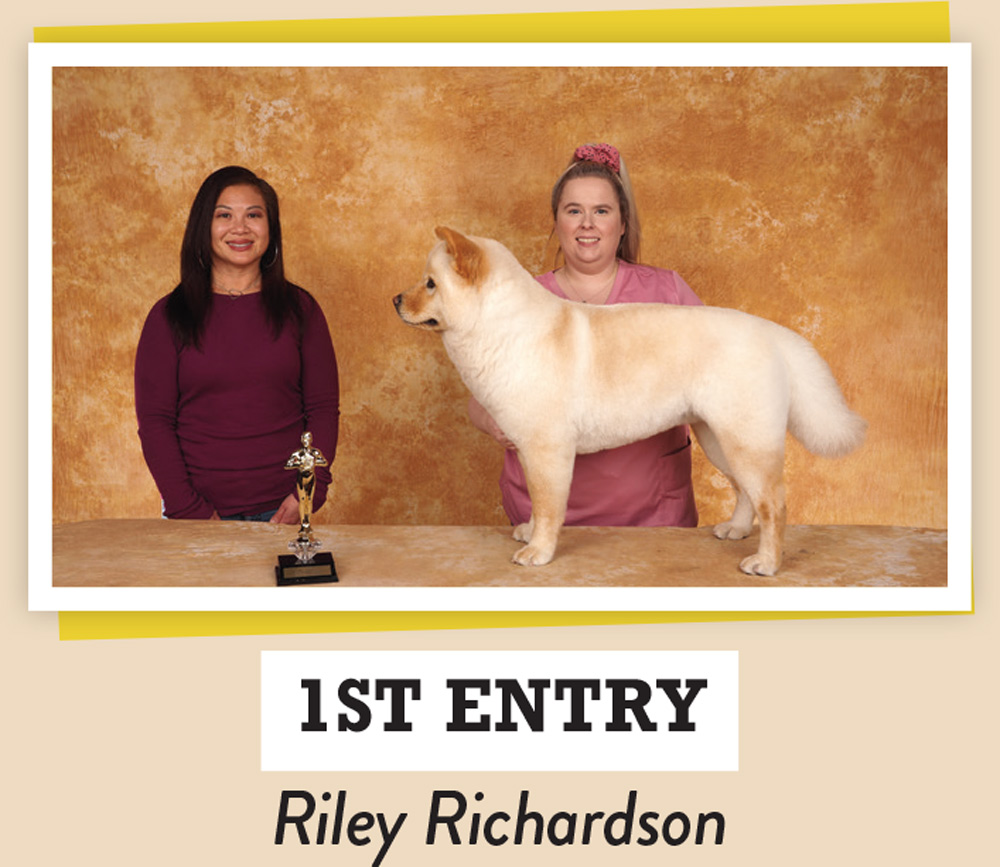 Riley Richardson posing with a dog and a trophy