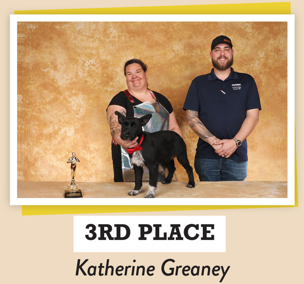 Katherine Greaney posing with dogs and a trophy