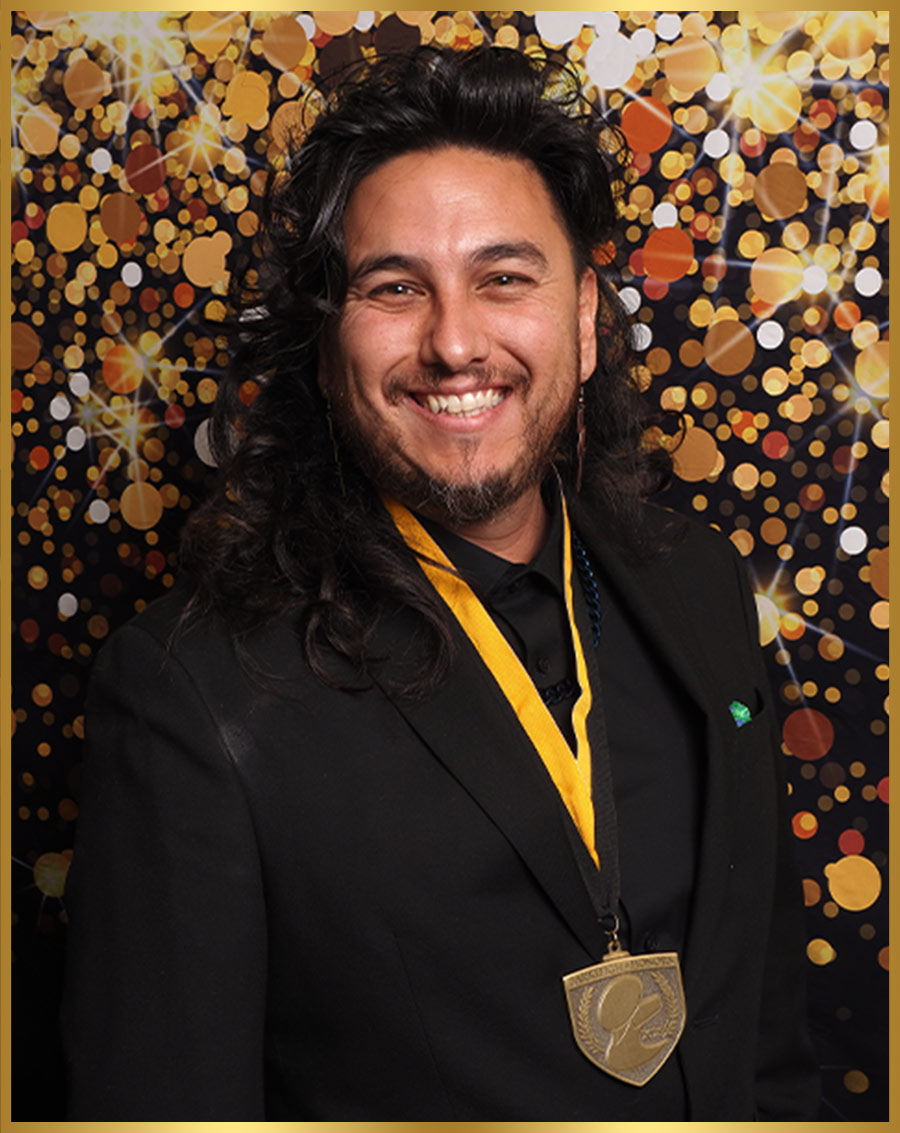 Nathan Austin pictured wearing a yellow ribboned medal around his neck