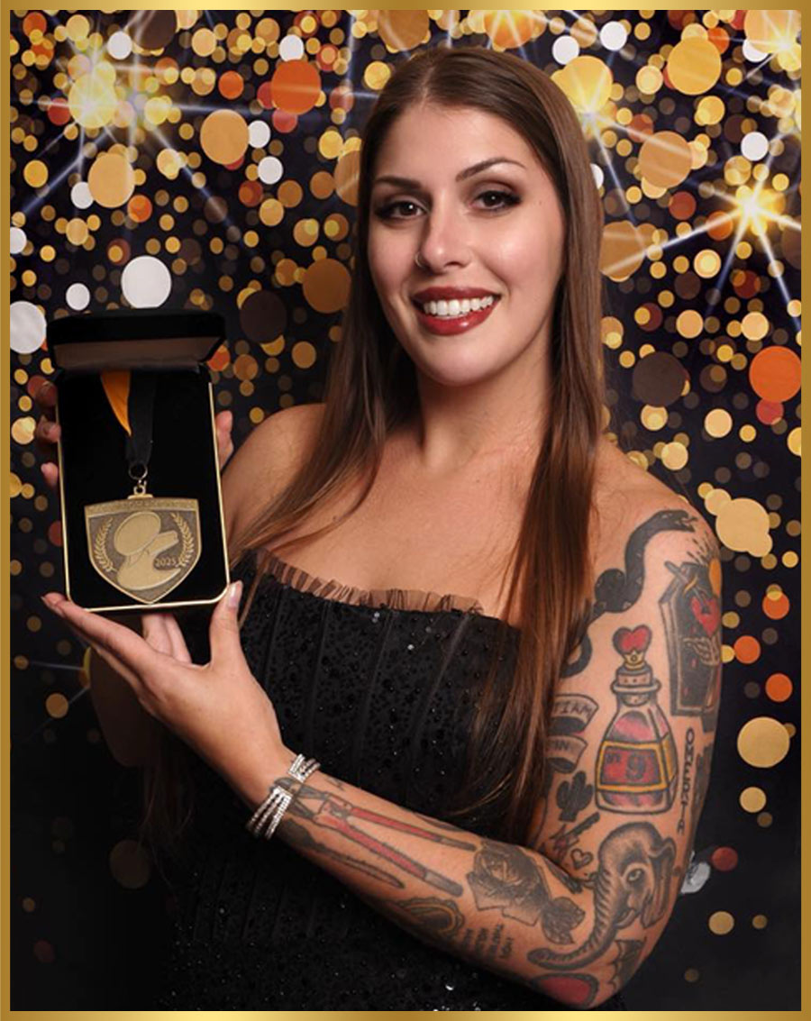 Rachel Colant pictured holding a medal in a presentation box