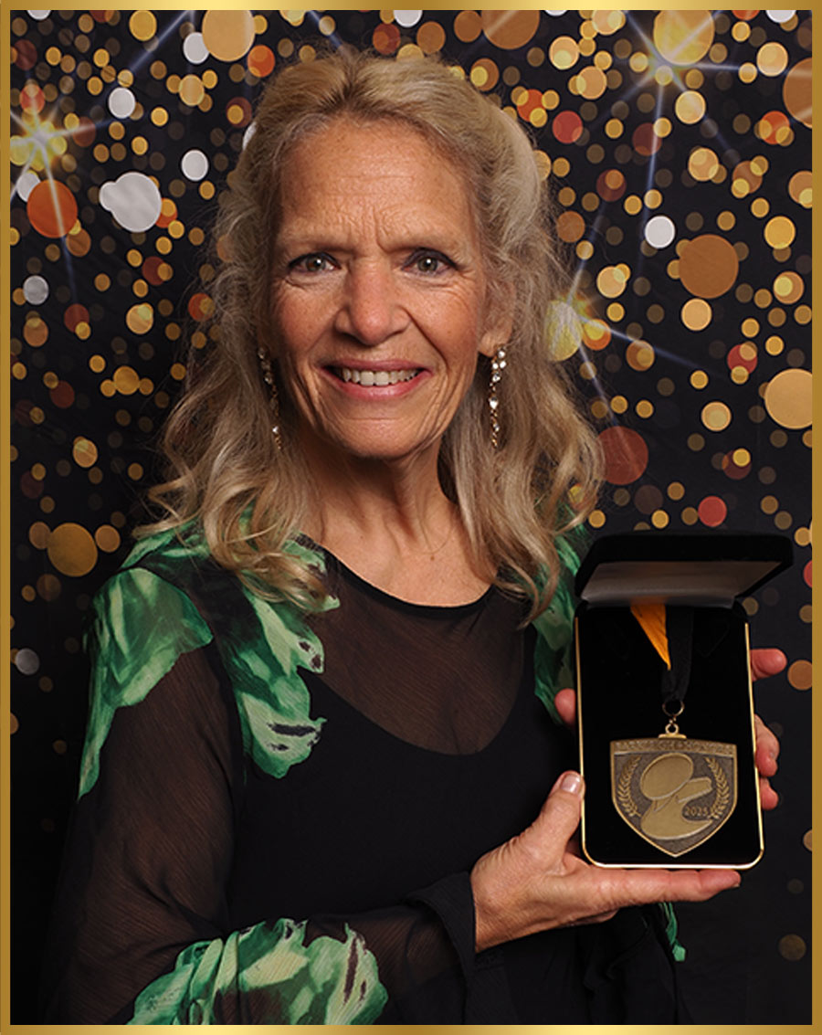 Jennifer Bishop Jenkins pictured holding a medal in a presentation box