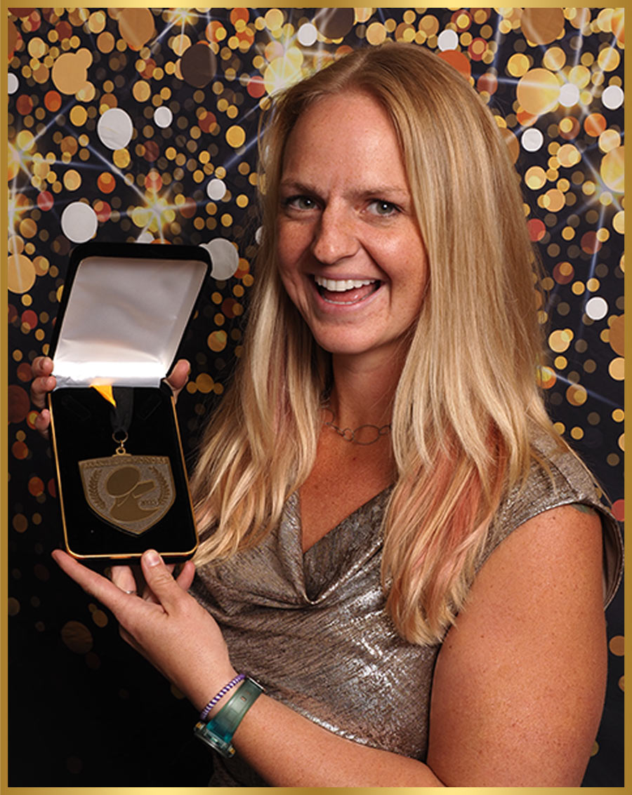Madeline Rothwell pictured holding a medal in a presentation box