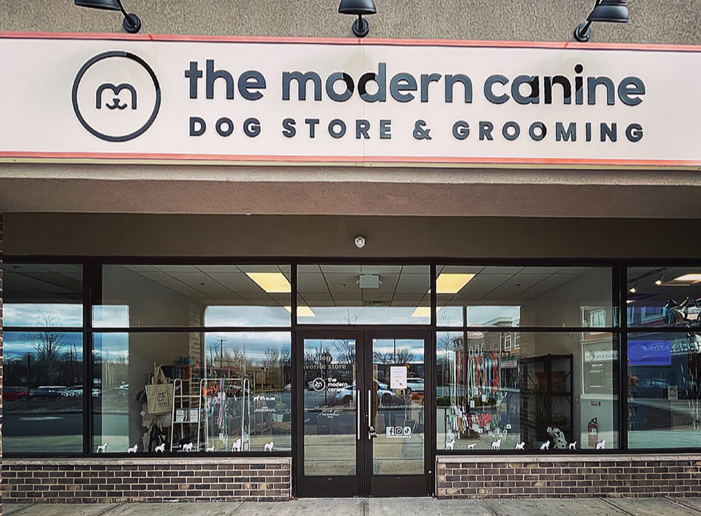 Exterior view of The Modern Canine storefront with signage and large windows looking into the shop.