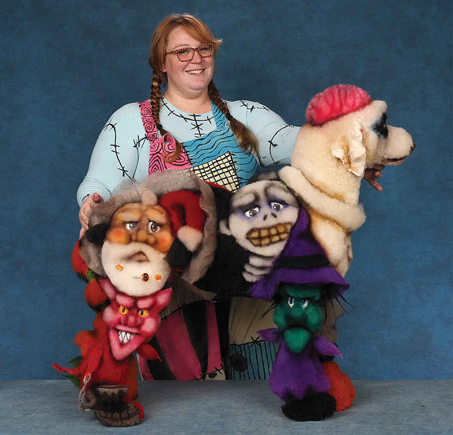 A woman in a costume displays the opposite side of a Standard Poodle groomed with The Nightmare Before Christmas characters.